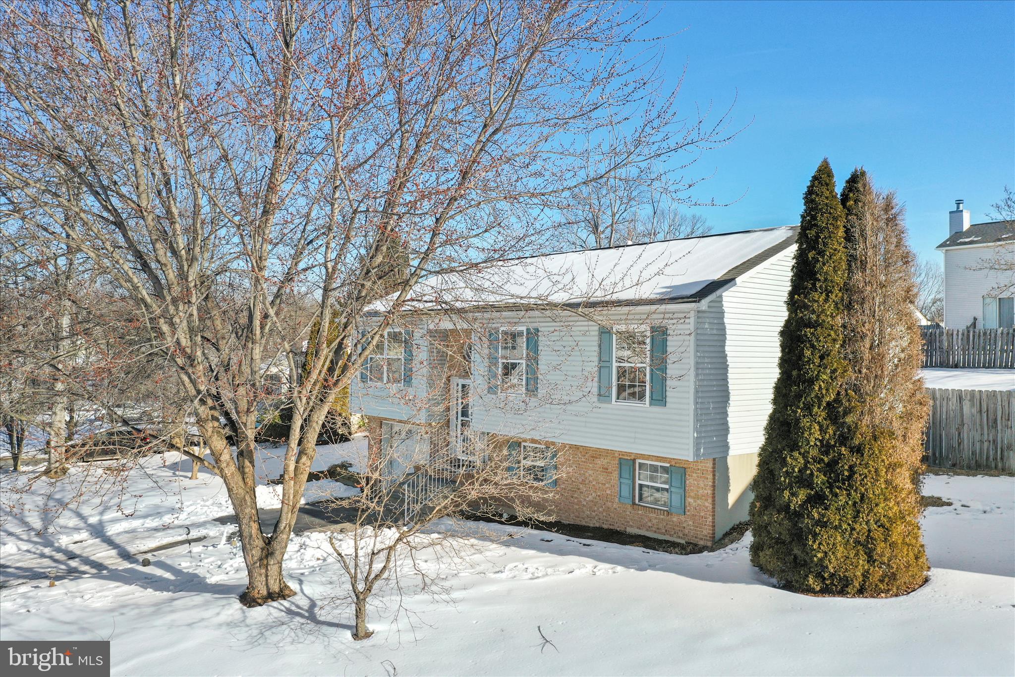 137 Woodrow Road Winchester, VA 22602 - Photo 34 of 45 a view of a brick house next to a large tree