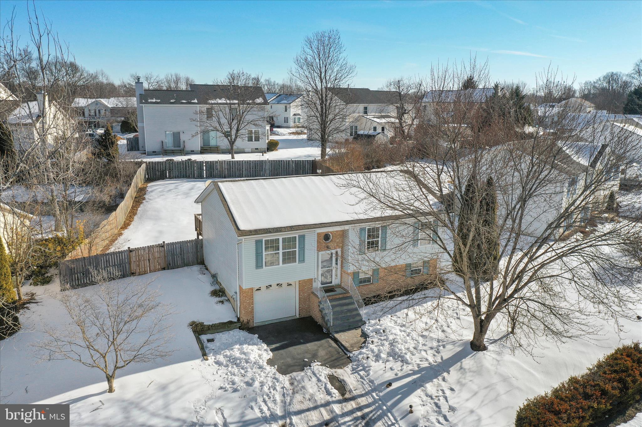 137 Woodrow Road Winchester, VA 22602 - Photo 37 of 45 a view of a house with a yard covered in snow
