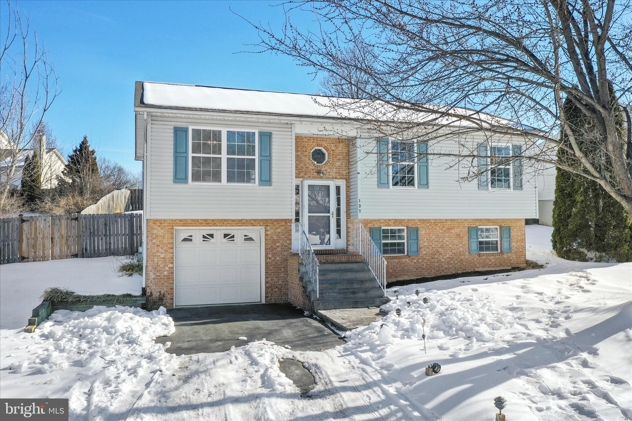 137 Woodrow Road Winchester, VA 22602 - Photo 4 of 45 a view of a white house with large windows
