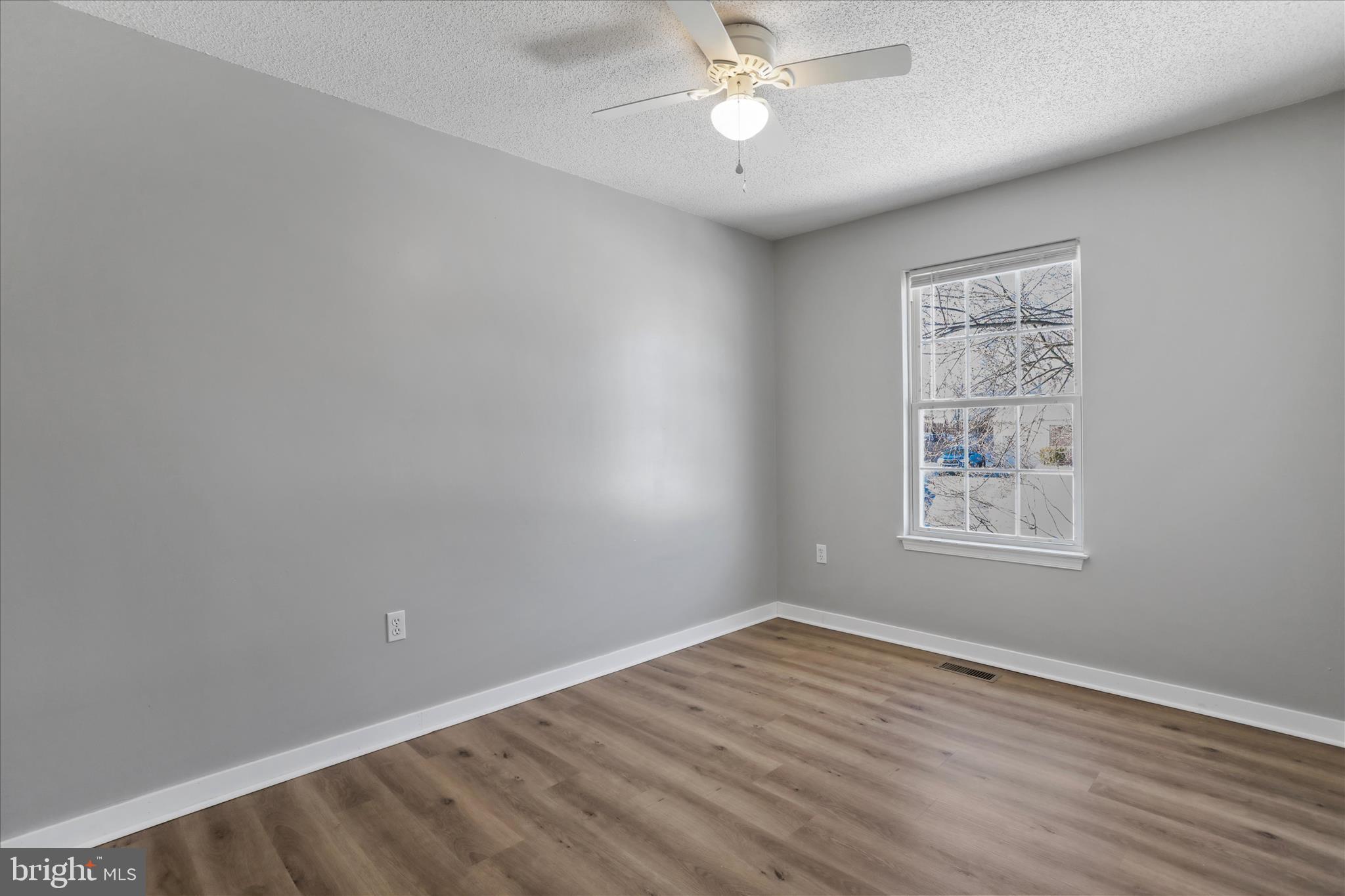 137 Woodrow Road Winchester, VA 22602 - Photo 7 of 45 wooden floor in an empty room with a window
