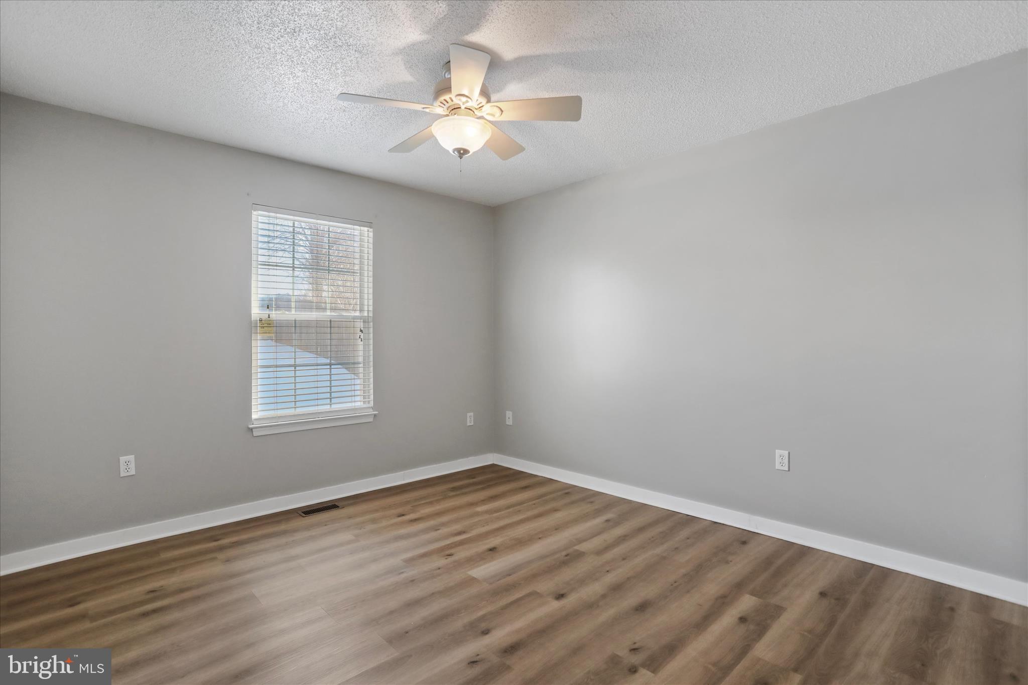 137 Woodrow Road Winchester, VA 22602 - Photo 9 of 45 an empty room with wooden floor and window