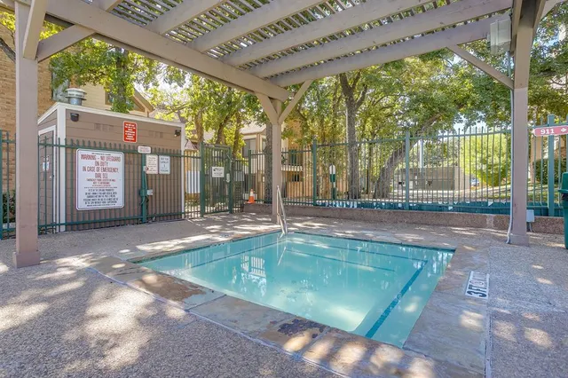 a view of a swimming pool with a yard