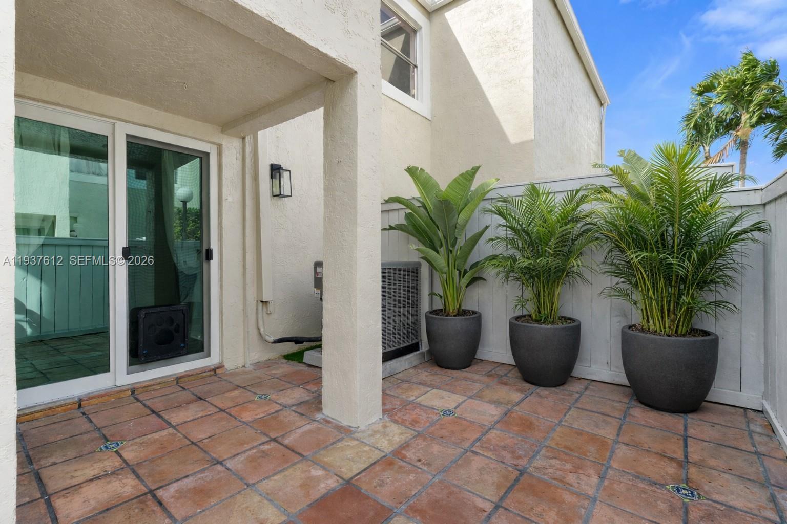 6830 Southwest 45th Lane, Unit 2 Miami, FL 33155 - Photo 14 of 21 a view of a potted plants in backyard of a house