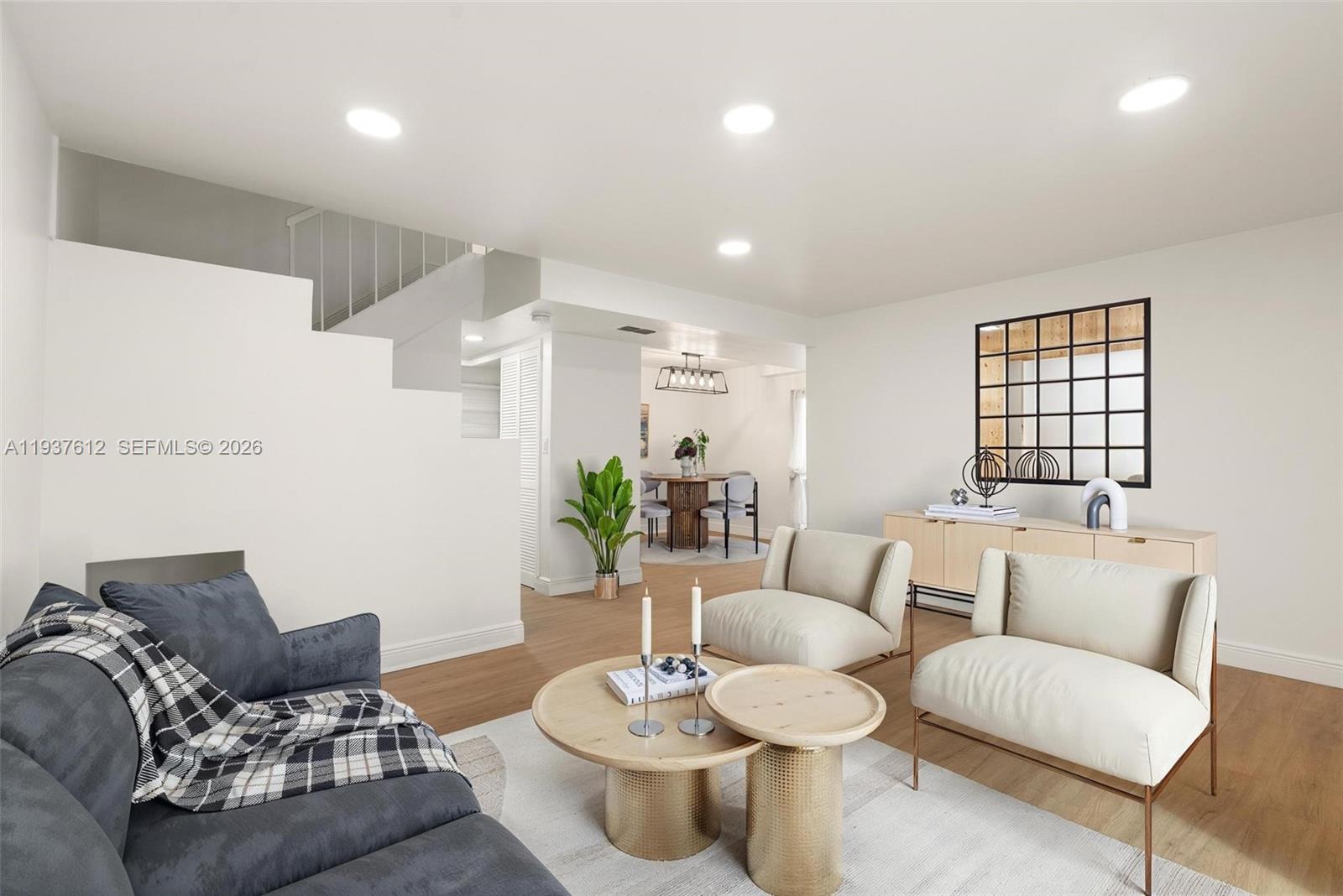 6830 Southwest 45th Lane, Unit 2 Miami, FL 33155 - Photo 2 of 21 a living room with furniture and wooden floor