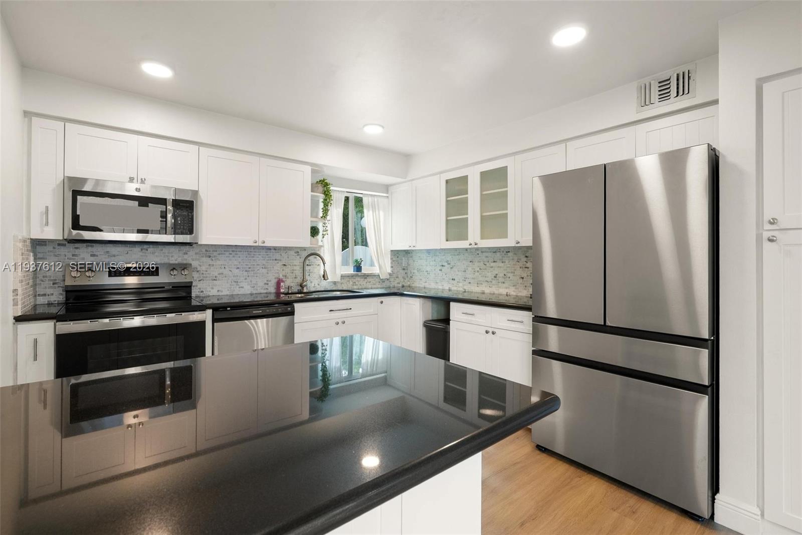 6830 Southwest 45th Lane, Unit 2 Miami, FL 33155 - Photo 4 of 21 a kitchen with stainless steel appliances granite countertop a refrigerator a stove a sink and a granite counter tops