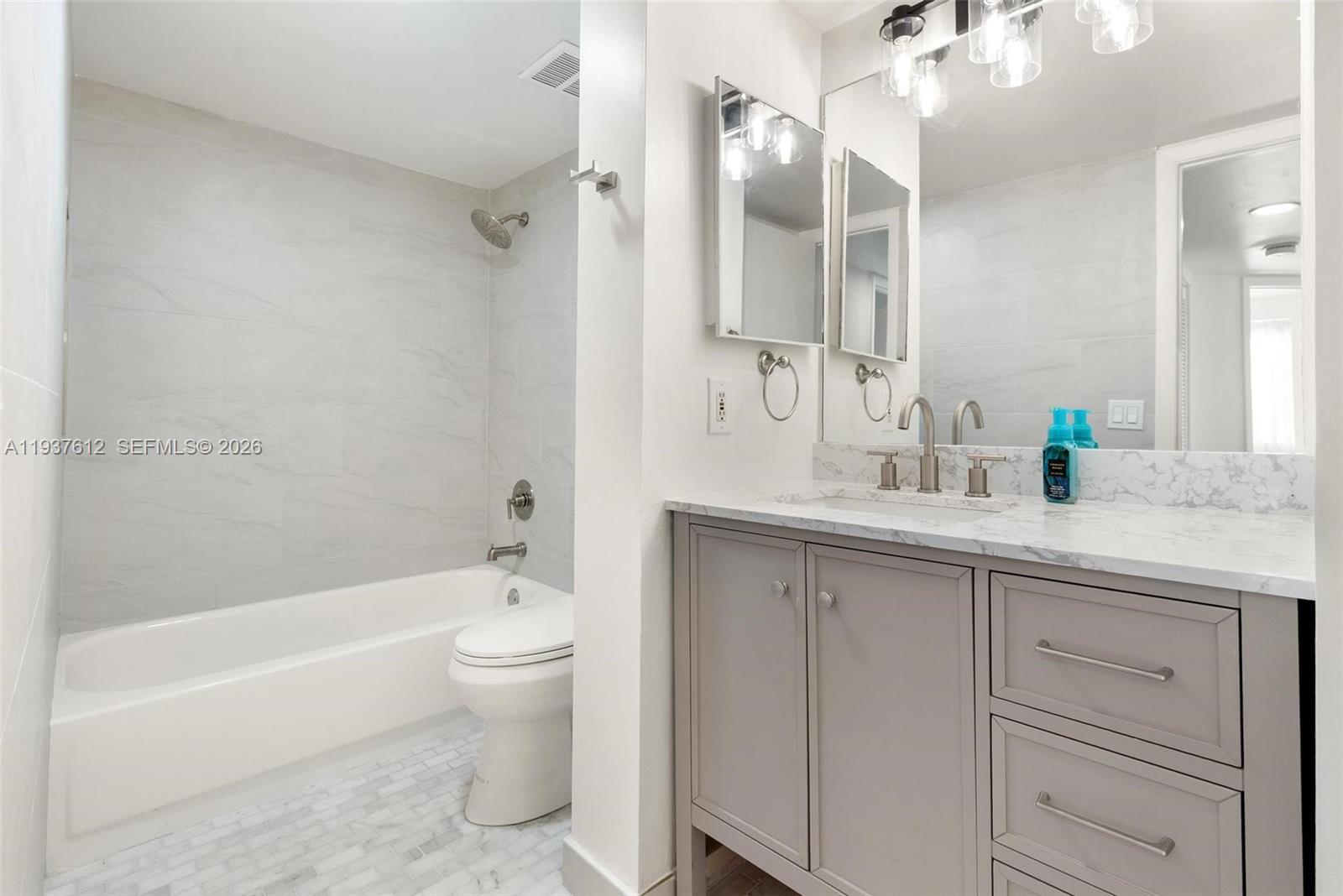 6830 Southwest 45th Lane, Unit 2 Miami, FL 33155 - Photo 10 of 21 a bathroom with a granite countertop sink toilet and shower