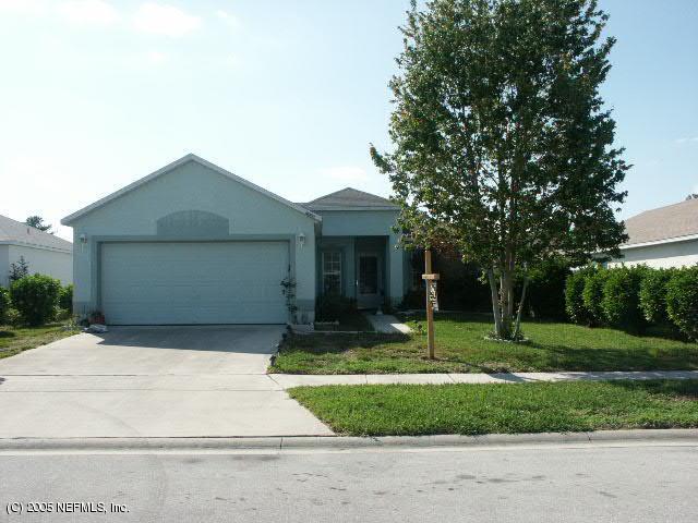 2698 R S Bailey Drive Jacksonville, FL 32246 - Photo 1 of 1 a front view of a house with a yard and garage