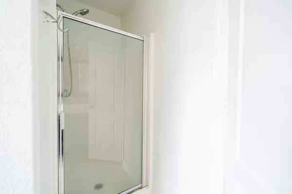 a bathroom with a glass shower door