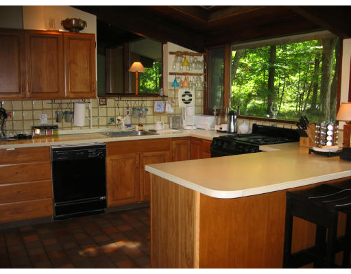 50 Woodside Road Harvard, MA 01451 - Photo 2 of 13 a kitchen with stainless steel appliances granite countertop a sink a stove and a microwave