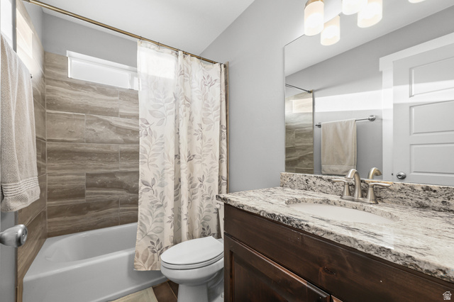 2056 West Ridgeline Road Stockton, UT 84071 - Photo 30 of 50 Bathroom featuring a dark wood-finish vanity with a granite countertop and an undermount sink