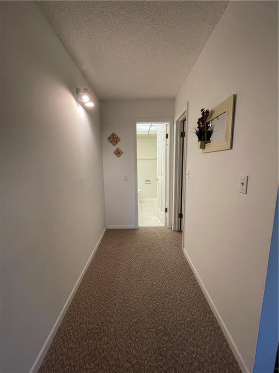 9233 Southwest 8th Street, Unit 220 Boca Raton, FL 33428 - Photo 16 of 23 a view of a room with a hallway