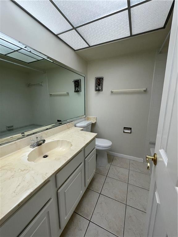 9233 Southwest 8th Street, Unit 220 Boca Raton, FL 33428 - Photo 19 of 23 a bathroom with a granite countertop sink a toilet and with shower