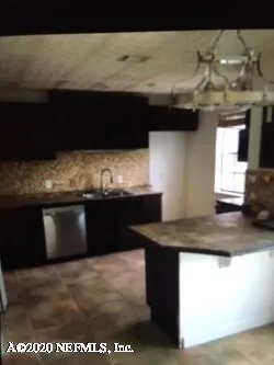 a kitchen with a sink and a refrigerator