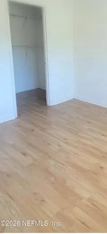 an empty room with wooden floor