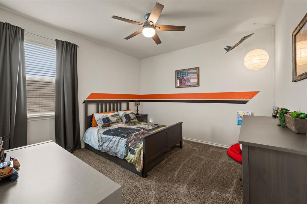 15817 White Mill Road Fort Worth, TX 76177 - Photo 22 of 27 a bedroom with a bed and a chandelier