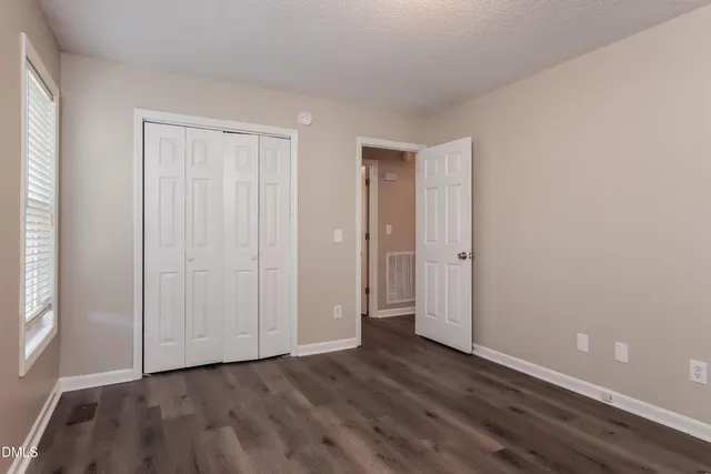a view of an empty room and wooden floor