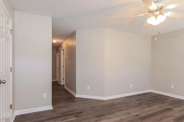 a view of a room with wooden floor