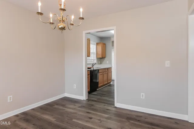 wooden floor in an empty room with a mirror