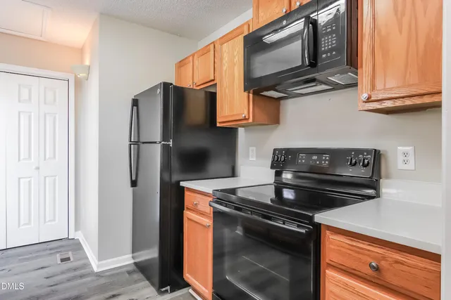 a kitchen with stainless steel appliances granite countertop a stove and a refrigerator