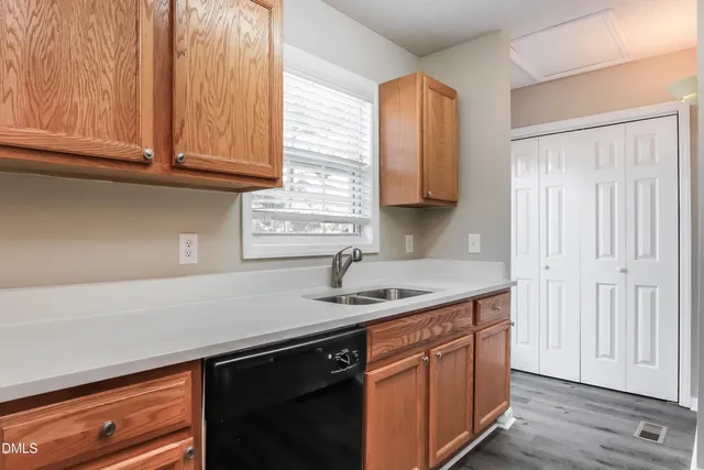 a kitchen with stainless steel appliances granite countertop a sink a stove and cabinets