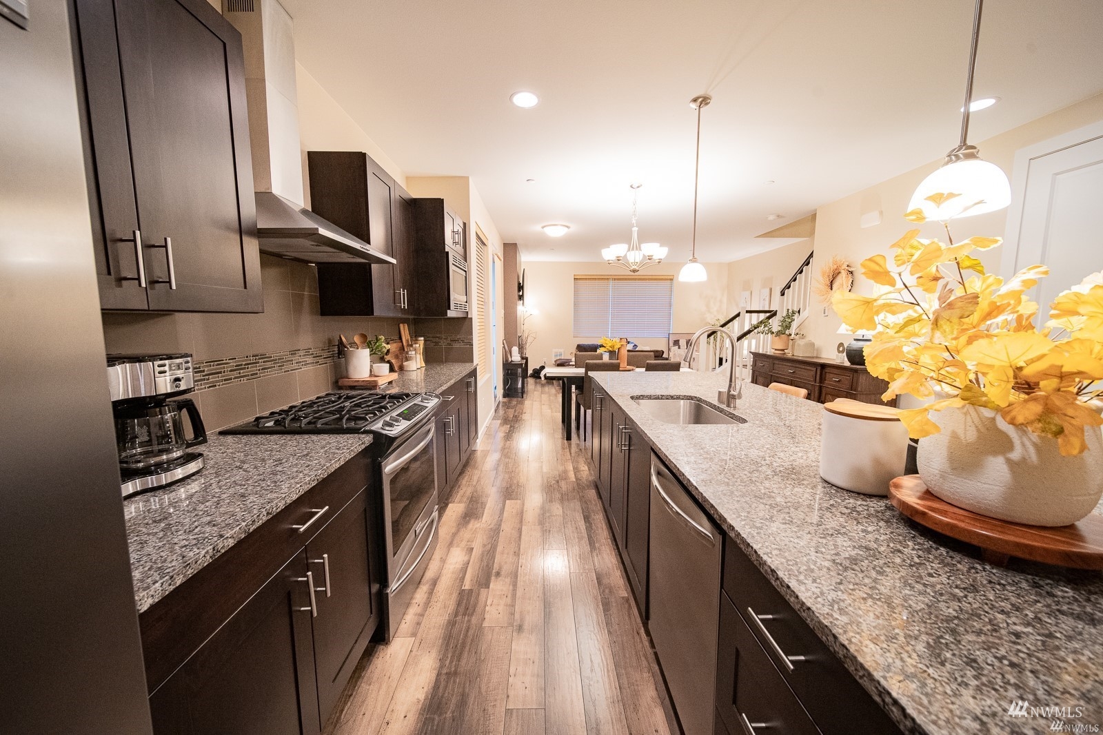 870 Southwest 96th Place Seattle, WA 98106 - Photo 11 of 27 a kitchen with kitchen island granite countertop stainless steel appliances lots of counter top space