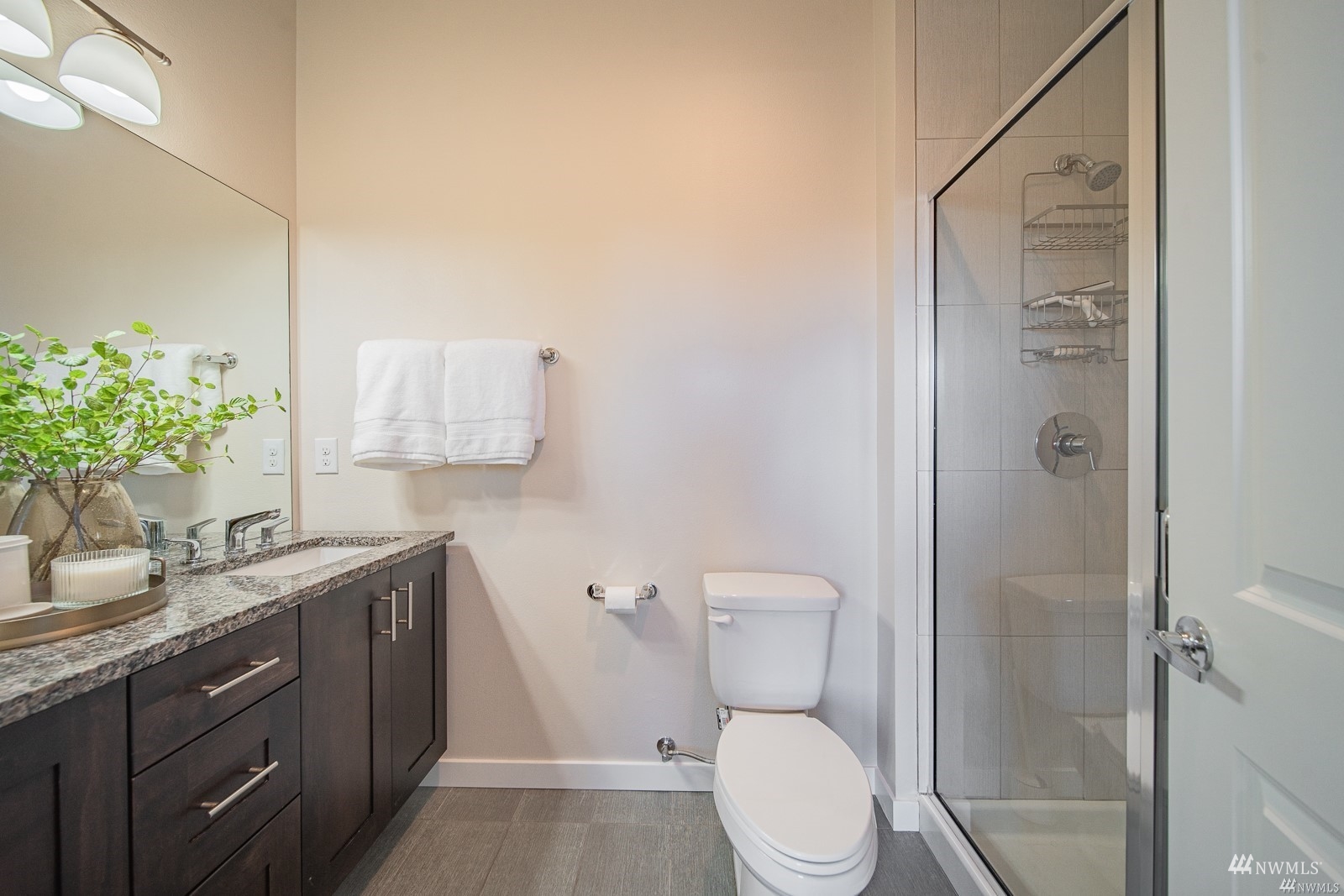 870 Southwest 96th Place Seattle, WA 98106 - Photo 24 of 27 a bathroom with a granite countertop sink a toilet and shower