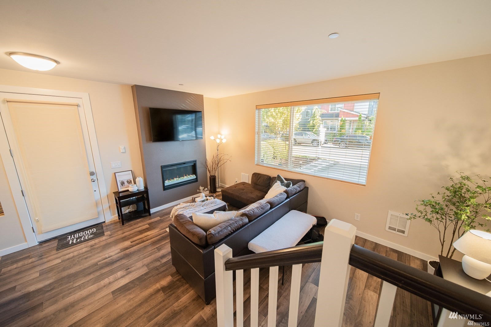 870 Southwest 96th Place Seattle, WA 98106 - Photo 6 of 27 a living room with furniture a flat screen tv and a fireplace