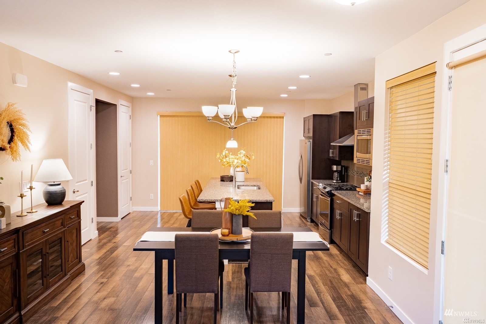 870 Southwest 96th Place Seattle, WA 98106 - Photo 8 of 27 a kitchen with stainless steel appliances a dining table chairs stove and refrigerator