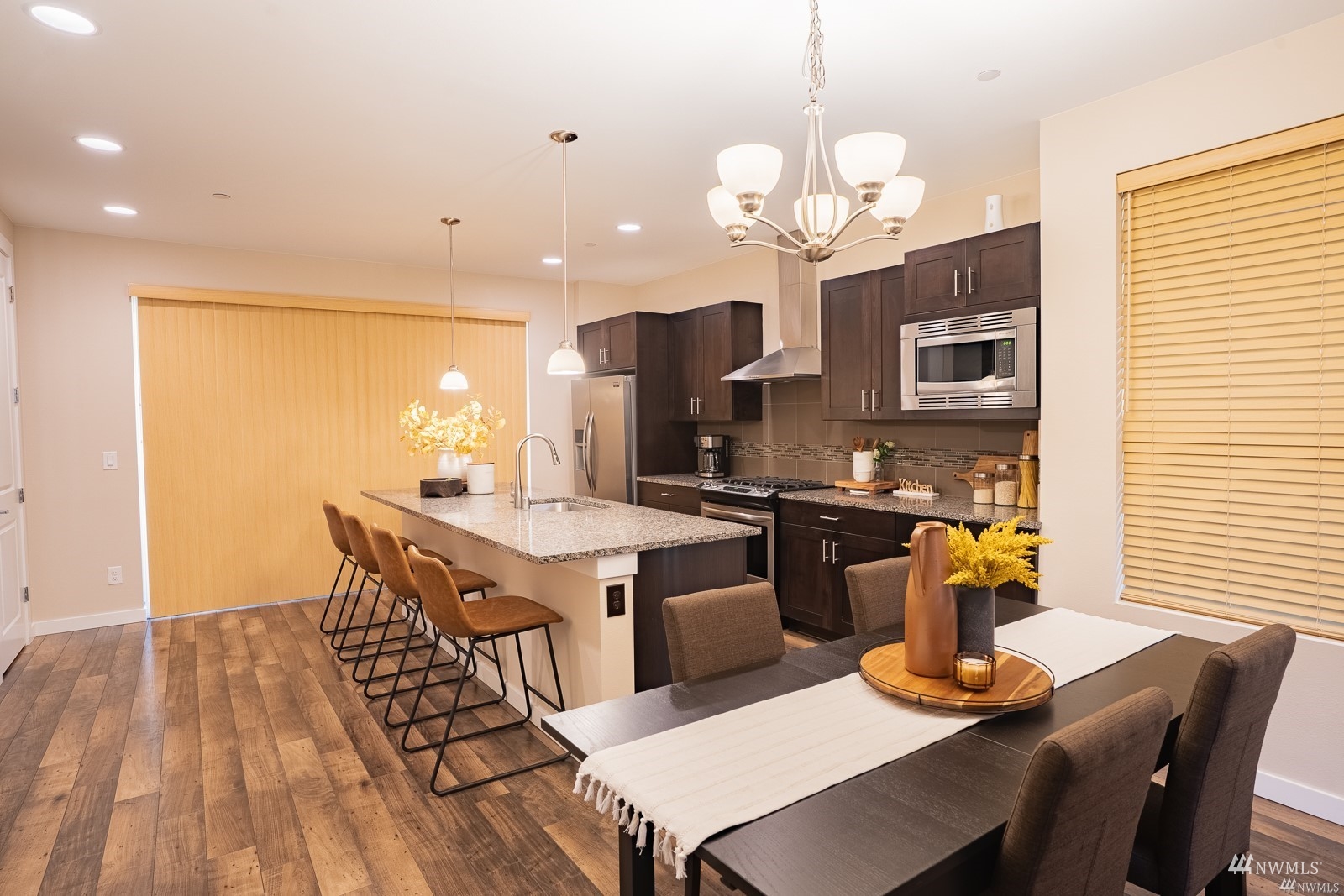 870 Southwest 96th Place Seattle, WA 98106 - Photo 9 of 27 a kitchen with a dining table chairs and stove