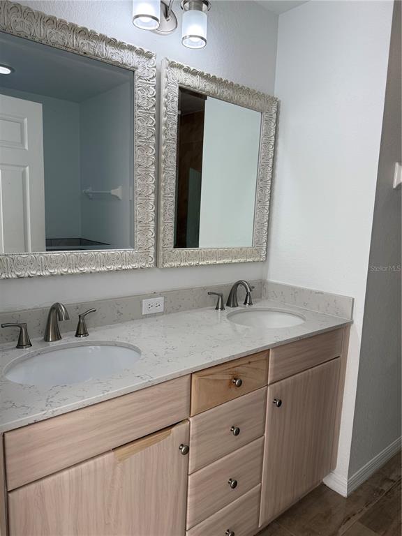 4688 Heather Terrace North Port, FL 34286 - Photo 22 of 35 a bathroom with double sink and a mirror