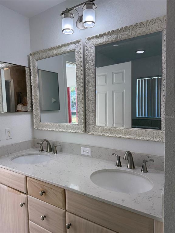 4688 Heather Terrace North Port, FL 34286 - Photo 23 of 35 a bathroom with a sink and a mirror