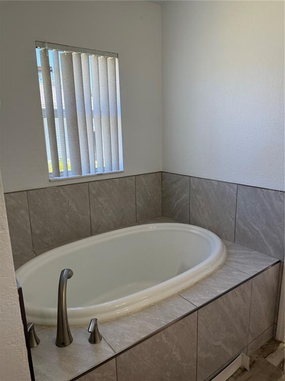 4688 Heather Terrace North Port, FL 34286 - Photo 25 of 35 a bathroom with a bathtub
