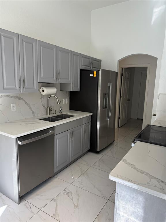 4688 Heather Terrace North Port, FL 34286 - Photo 10 of 35 a kitchen with stainless steel appliances a refrigerator sink and cabinets