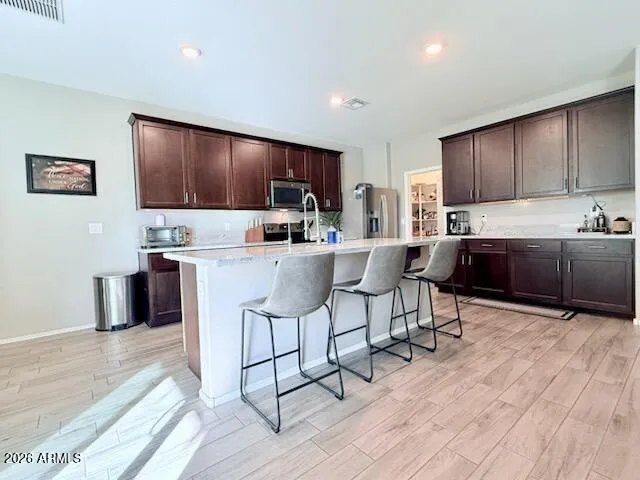 a kitchen with a sink cabinets and wooden floor