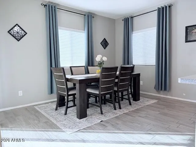 a view of a dining room with furniture and window