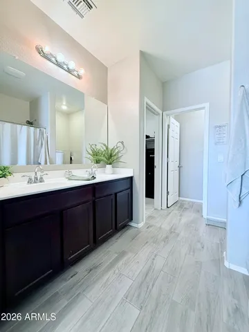 a bathroom with a double vanity sink and a mirror