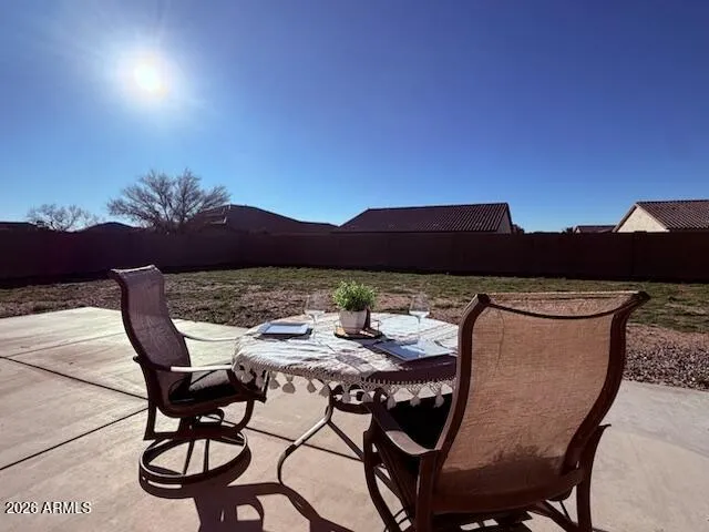 a view of a chairs and table in patio