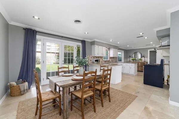 a hallway with wooden floor and white walls