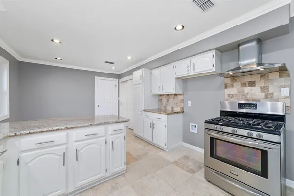 a kitchen with stainless steel appliances granite countertop a refrigerator sink and cabinets