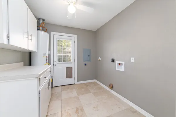 a kitchen with white cabinets and appliances