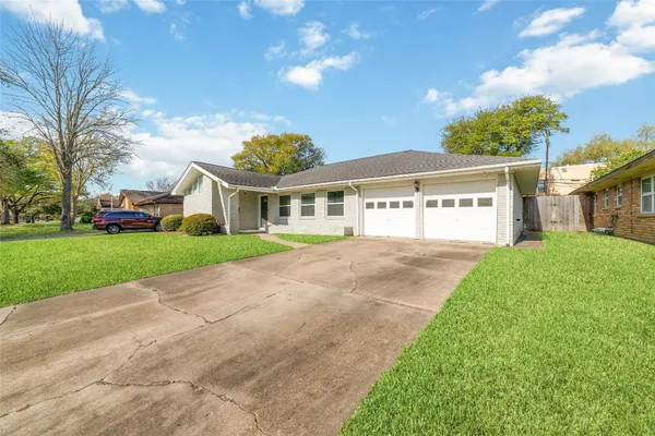 a view of house with yard and green space