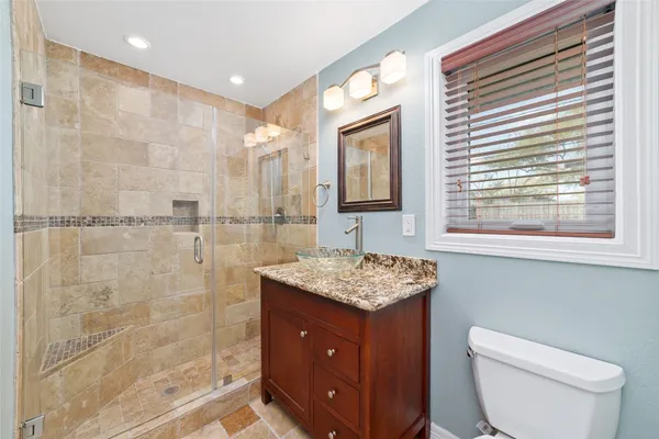 a bedroom with a bed couch and a window