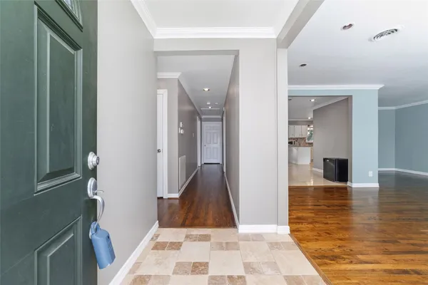 a view of a hallway with wooden floor and a living room