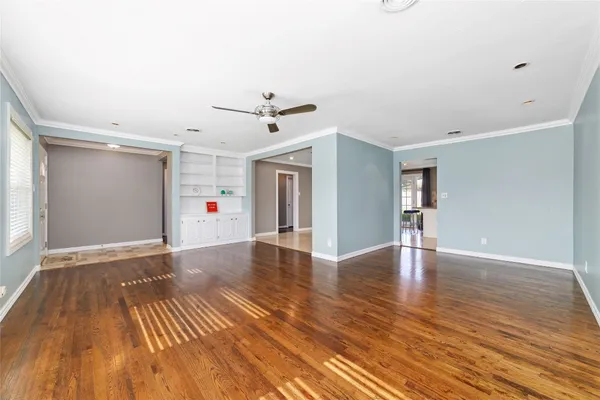 a view of an empty room with wooden floor