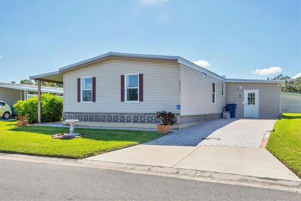 a view of a house with swimming pool and a yard