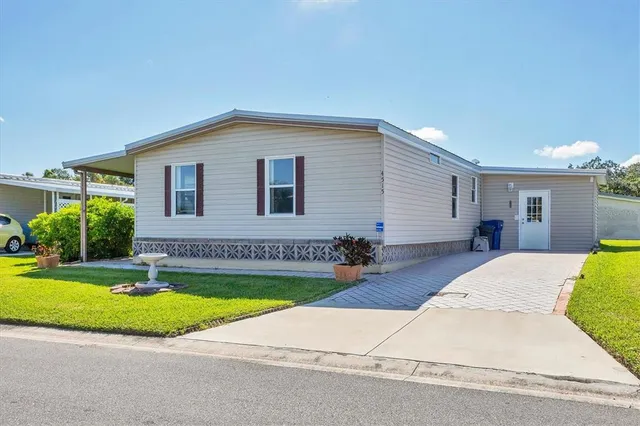 a view of a house with swimming pool and a yard