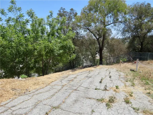 a view of a yard covered with snow in front of house
