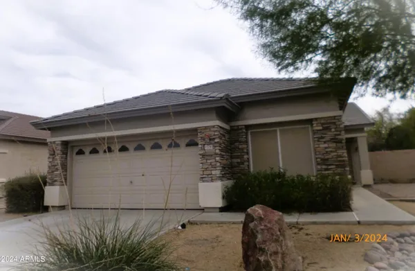a front view of a house with garage