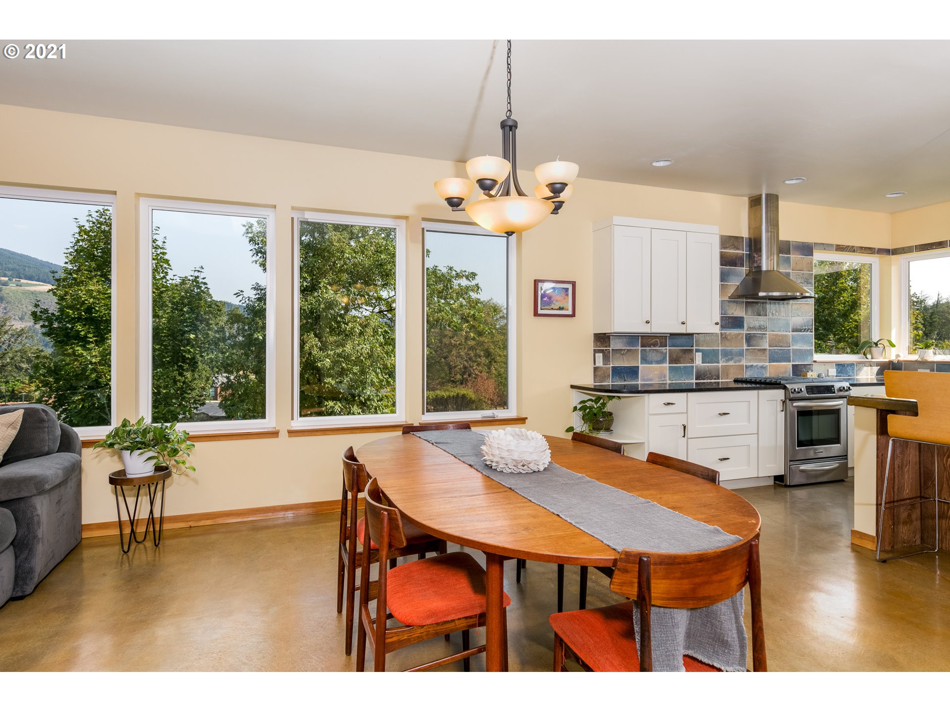 503 Frankton Road Hood River, OR 97031 - Photo 9 of 31 a dining room with stainless steel appliances granite countertop a dining table chairs and a floor to ceiling window