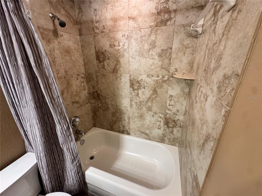 6315 Rosefinch Court, Unit 101 Lakewood Ranch, FL 34202 - Photo 15 of 30 a bathroom with a bathtub